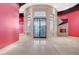 Grand foyer featuring large glass doors, marble floors, and unique architectural details throughout at 9713 Highridge Dr, Las Vegas, NV 89134