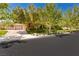 Charming single-story home features a well-manicured lawn and a two-car garage with mature landscaping at 9713 Highridge Dr, Las Vegas, NV 89134