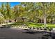 Charming single-story home featuring lush green landscaping, mature trees, and neatly trimmed hedges, creating inviting curb appeal at 9713 Highridge Dr, Las Vegas, NV 89134