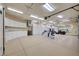 Spacious garage with ample storage cabinets and a dedicated workout area with equipment at 9713 Highridge Dr, Las Vegas, NV 89134