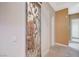 Hallway featuring marble floors and a decorative wrought iron door to the wine room at 9713 Highridge Dr, Las Vegas, NV 89134