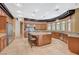 Open kitchen with island seating, granite countertops, stainless steel appliances, and custom wood cabinetry at 9713 Highridge Dr, Las Vegas, NV 89134