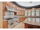 Close up of kitchen with stainless appliances and granite countertops, next to a curved breakfast bar at 9713 Highridge Dr, Las Vegas, NV 89134