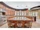 Well-equipped kitchen with granite counters, stainless steel appliances, bar seating, and custom cabinetry at 9713 Highridge Dr, Las Vegas, NV 89134