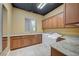 Convenient laundry room featuring built-in cabinets, granite counters, sink, washer, and dryer at 9713 Highridge Dr, Las Vegas, NV 89134