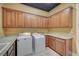 Bright laundry room with ample cabinet space, washer, dryer, and granite counters at 9713 Highridge Dr, Las Vegas, NV 89134