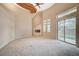 Bright living room with fireplace, ceiling fan, and sliding glass doors to outdoor space at 9713 Highridge Dr, Las Vegas, NV 89134