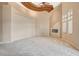 Open living room with fireplace, high ceilings, ceiling fan, and lots of natural light at 9713 Highridge Dr, Las Vegas, NV 89134