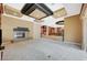 Spacious living room with a fireplace, custom ceiling, and travertine steps up to kitchen area at 9713 Highridge Dr, Las Vegas, NV 89134