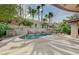 Lush backyard featuring a sparkling pool, spa, and a captivating stone waterfall, ideal for relaxation at 9713 Highridge Dr, Las Vegas, NV 89134
