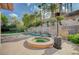 Backyard pool and spa accented by a stone waterfall feature and surrounded by lush landscaping at 9713 Highridge Dr, Las Vegas, NV 89134