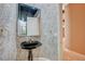 Stylish powder room featuring pedestal sink and decorative mirror at 9713 Highridge Dr, Las Vegas, NV 89134