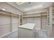 Large walk-in closet features custom shelving, drawers and center storage island at 9713 Highridge Dr, Las Vegas, NV 89134