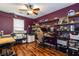 Bright bedroom with wood floor featuring shelves, and desk at 9925 Turquoise Glass Ct, Las Vegas, NV 89178