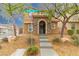 Inviting two-story home boasting a stone-accented entry and well-maintained landscaping at 9925 Turquoise Glass Ct, Las Vegas, NV 89178