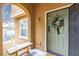 Welcoming front porch with a decorative wreath and charming bench seating area at 9925 Turquoise Glass Ct, Las Vegas, NV 89178