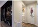 Hallway featuring hardwood floors, and a view of the laundry room and media center at 9925 Turquoise Glass Ct, Las Vegas, NV 89178
