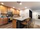 Kitchen with stainless steel appliances, island seating and natural wood cabinets at 9925 Turquoise Glass Ct, Las Vegas, NV 89178