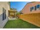 Cozy backyard featuring a covered patio and artificial turf for easy maintenance and year-round enjoyment at 10931 Sardinia Sands Dr, Las Vegas, NV 89141