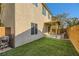 Inviting backyard with artificial grass and a covered patio, perfect for outdoor relaxation and entertaining at 10931 Sardinia Sands Dr, Las Vegas, NV 89141