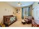 Cozy Bedroom with a crib, rocking chair, and natural light from the window at 10931 Sardinia Sands Dr, Las Vegas, NV 89141