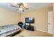 Bedroom with tan walls, ceiling fan and carpet floors at 10931 Sardinia Sands Dr, Las Vegas, NV 89141