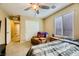 Bedroom with tan walls, ceiling fan and carpet floors at 10931 Sardinia Sands Dr, Las Vegas, NV 89141