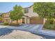 Two-story home with a two-car garage and desert landscaping at 10931 Sardinia Sands Dr, Las Vegas, NV 89141