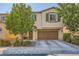 Two-story home with a two car garage and desert landscaping at 10931 Sardinia Sands Dr, Las Vegas, NV 89141