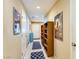 Hallway with tan walls, tile floors, and decorative rugs at 10931 Sardinia Sands Dr, Las Vegas, NV 89141