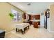Eat-in kitchen with cherry wood cabinets, granite countertops, stainless steel appliances, and a cozy dining area at 10931 Sardinia Sands Dr, Las Vegas, NV 89141