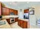 Well-appointed kitchen features rich wood cabinetry, granite counters, stainless appliances, and a center island at 10931 Sardinia Sands Dr, Las Vegas, NV 89141