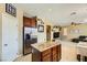 Open kitchen view featuring granite counters, a center island, and stainless steel appliances at 10931 Sardinia Sands Dr, Las Vegas, NV 89141