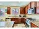 This kitchen features stainless steel appliances, granite countertops, and wood cabinetry at 10931 Sardinia Sands Dr, Las Vegas, NV 89141