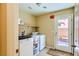 The laundry room includes a washing machine, dryer, and built-in shelving at 10931 Sardinia Sands Dr, Las Vegas, NV 89141