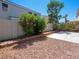 Backyard boasting vibrant flowering shrubs, low maintenance landscape and concrete patio area at 1153 Stormy Valley Rd, Las Vegas, NV 89123