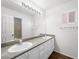 Spacious bathroom with a double vanity and bright natural light from the window at 1153 Stormy Valley Rd, Las Vegas, NV 89123