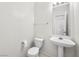 Clean, well-maintained bathroom with a toilet, sink, mirror, and towel rack for added convenience at 1153 Stormy Valley Rd, Las Vegas, NV 89123
