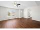 Spacious bedroom features wood floors, abundant natural light, and a ceiling fan for added comfort at 1153 Stormy Valley Rd, Las Vegas, NV 89123
