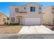 Two-story home with a two-car garage and low maintenance desert landscaping at 1153 Stormy Valley Rd, Las Vegas, NV 89123