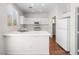 Well-lit kitchen with white cabinets, appliances, and breakfast bar area perfect for casual dining at 1153 Stormy Valley Rd, Las Vegas, NV 89123