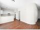 Bright kitchen with white cabinetry and modern appliances flows into the living area with wood flooring at 1153 Stormy Valley Rd, Las Vegas, NV 89123