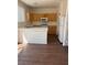 Bright kitchen featuring wooden cabinets, white appliances, and a breakfast bar at 1153 Stormy Valley Rd, Las Vegas, NV 89123