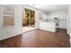 Open-concept kitchen features stainless steel appliances, white cabinets, and access to a private backyard at 1153 Stormy Valley Rd, Las Vegas, NV 89123