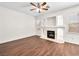 Bright living room with hardwood floors, fireplace, and a ceiling fan at 1153 Stormy Valley Rd, Las Vegas, NV 89123