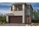 Inviting two-story home featuring a balcony, a neutral color palette, and an attached two-car garage at 143 Silver Run Ln, Las Vegas, NV 89138