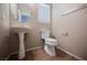 Powder room features a pedestal sink and a modern toilet at 1580 Wild Willey Way, Henderson, NV 89002