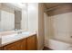 Bathroom featuring single sink and shower over tub with white tile at 1580 Wild Willey Way, Henderson, NV 89002