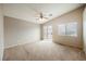 Spacious carpeted bedroom with ceiling fan and sliding doors to balcony at 1580 Wild Willey Way, Henderson, NV 89002