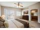 Comfortable bedroom with a king bed, a private balcony, an ensuite bathroom and carpeted floors at 1580 Wild Willey Way, Henderson, NV 89002